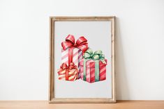 a painting of three wrapped presents on a table next to a white wall and wooden frame