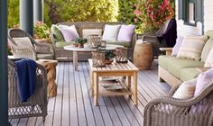 an outdoor living area with wicker furniture