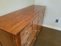 a large wooden dresser sitting in a room next to a carpeted floor and wall