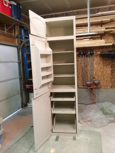 an empty storage cabinet in the middle of a garage