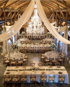 an image of a wedding venue with chandelier and tables set up for the reception