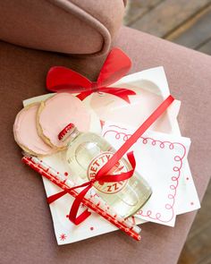 a bottle of booze sitting on top of a table next to cookies and candy