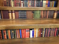 the books are lined up on the shelves