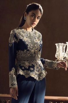 Blue peplum top with floral embroidered motifs and cutwork detail. Paired with layered sharara.
Component: 2
Embroidered
Neckine: Round
Sleeve Length: Full
Fabric: Crepe
Color: Blue
Dori and zardosi embroidery
Layered sharara
Cutwork detail - Aza Fashions Elegant Sharara With Floral Embroidery And Peplum, Elegant Floral Embroidered Sharara With Peplum, Elegant Peplum Sharara With Floral Embroidery, Elegant Floral Embroidered Peplum Sharara, Elegant Embroidered Top With Traditional Drape, Traditional Elegant Top With Intricate Embroidery, Elegant Blue Tops With Traditional Drape, Fitted Floral Embroidered Evening Sharara, Fitted Peplum Dress With Intricate Embroidery