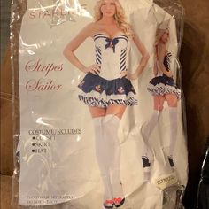 a woman in a sailor costume standing next to a cardboard bag with the caption's name on it