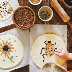 a child is working on some art work with food and other things to make it