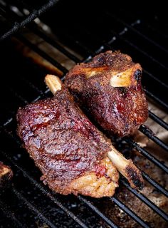 two steaks are cooking on the grill