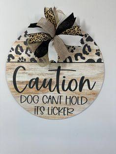 a wooden sign that says caution dog can't hold it's licker