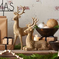 christmas decorations and gifts on display in front of a brick wall