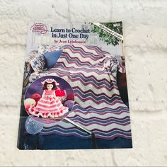 a crochet book with an image of a doll on it