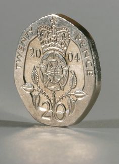 an old british one pound coin with the royal seal on it's reverse side