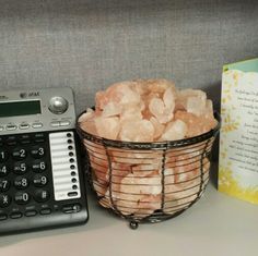 a basket full of sugar next to a calculator and book on a desk