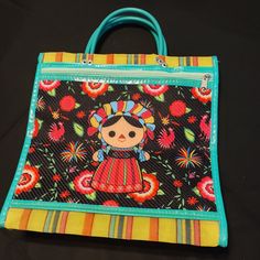 a handbag with an image of a mexican doll on it