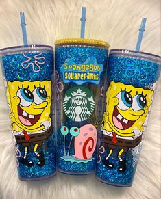 three starbucks cups with spongebob characters on them