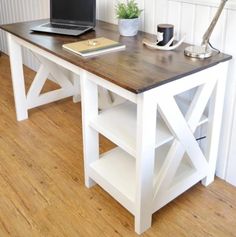 a laptop computer sitting on top of a wooden desk next to a lamp and bookshelf