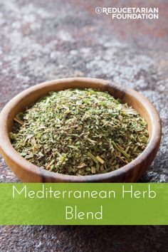 a wooden bowl filled with green herbs on top of a stone floor next to the words mediterranean herb blend