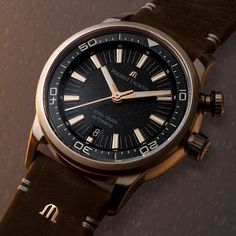 The Maurice Lacroix Pontos S Diver Watch in Bronze, with a 42mm case, epitomizes continuous improvement and accessible luxury. This elegant timepiece, driven by the automatic ML115 movement, features hours, minutes, seconds, and a date function at 6 o'clock, with a 38-hour power reserve and 28'800 vph frequency. Its 13mm thick bronze case, water-resistant to 300m, is complemented by a unidirectional rotating bezel, screwed crown, and a special engraving on the case back. The black lacquered dial, adorned with vintage beige Super-LumiNova indexes and yellow gold-plated hands, ensures readability. Finished with a 22mm brown leather strap featuring the Maurice Lacroix 'M' logo and a bronze pin buckle, this watch blends sumptuous materials with refined finishes, embodying sophistication and el Timeless Analog Watch Accessories, Timeless Analog Display Watch Accessories, Timeless Watch Accessories With Analog Display, Timeless Watch Bands With Analog Display And Round Dial, Timeless Automatic Chronograph Watch, Timeless Chronometer Watch With Round Dial, Luxury Watches With Analog Display, Timeless Watch Accessories With Date Indicator, Luxury Hampers