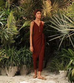 I'm a woodpecker carving out my destiny in a piece of wood that's still alive. A maroon printed coo-ord set with half elasticated pants and tapered trousers with side pockets. Knot up with this wrap around top with a lining and ruffle detailing on shoulder. Call it your home. Handcrafted in India Top -Lined -Ruffled shoulder detailing, Pants -Half elasticated -Side pockets -Lined Colour: Maroon (Bagru Printed) Wrap Tunic, Wrap Around Top, Red Two Piece, Bagru Print, Coord Set, Tapered Trousers, Pernia Pop Up Shop