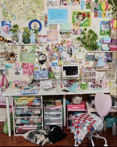 a cluttered desk with lots of stuff on the top and bottom shelves, along with many other items