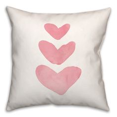 a pink heart pillow on a white background