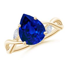 a yellow gold ring with an oval blue sapphire and three diamonds