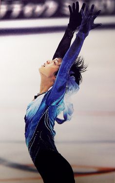 a female figure skating on an ice rink