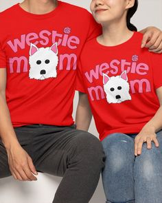 two people sitting next to each other wearing red shirts with westie mom on them