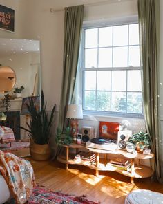 a living room filled with furniture and a large window