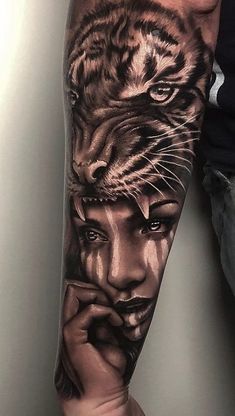 a man's arm with a tiger and woman tattoo on the left side of his arm