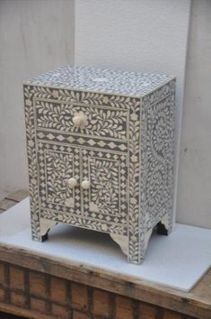 a white and black cabinet sitting on top of a table