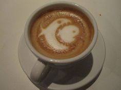 a cappuccino with a smiley face drawn on it