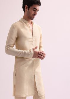 Introducing our regal beige embroidered sherwani set, a stunning amalgamation of elegance and grandeur. Highlighted with intricate cutdana, and hand embellished zardozi work, the sherwani is further accentuated with a stylishly designed high collar. Paired with a complementing kurta and pants, this silk outfit adds a modern twist to your traditional ensemble. Dry-clean only if required. Slight variation in color is possible due to digital photography. Kurta And Pants, Embroidered Sherwani, Rahul Khanna, Zardozi Work, Silk Outfit, Soho Nyc, Nehru Jackets, Western Wedding, Wedding Service