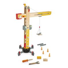 a wooden toy crane with construction tools around it