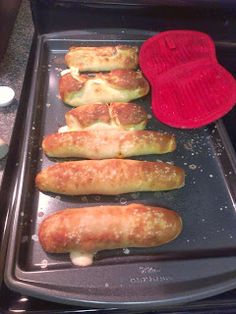 bread rolls are lined up on a baking sheet and ready to go into the oven