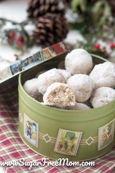 a green bowl filled with snowballs on top of a table