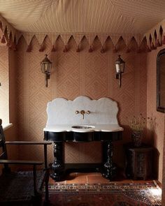 a bathroom with a sink, mirror and rug on the floor in front of it