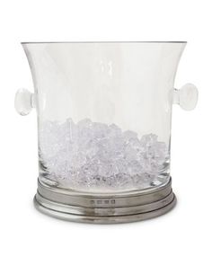 an ice bucket filled with lots of white crystal rocks on top of a metal stand