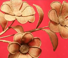 two gold flowers on a red background