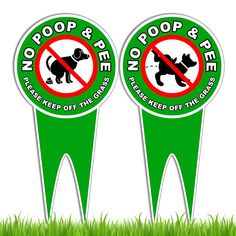 two green stickers with no poop and poop pee on them in the grass