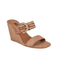 Nine West-Novalie Wedge Sandal Whether you're dressing up for a special occasion or adding flair to your casual outfits, the Novalie wedge sandal from Nine West is the perfect choice. Textured dual bands with an adjustable buckle closure and a chic square toe adorn the upper of this slip-on sandal. It is finished off with an espadrille wedge heel for added charm. Elegant Adjustable Wedge Sandals For Spring, Chic Adjustable Wedge Sandals With Heel Loop, Straw Wedge Sandals With Buckle Closure, Elegant Wedge Heel Sandals For Beach, Elegant Brown Wedge Sandals For Vacation, Adjustable Chic Wedge Heel Sandals, Chic Adjustable Wedge Heel Sandals, Chic Adjustable Wedge Sandals, Summer Wedge Sandals With Buckle Closure