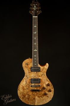 an electric guitar made out of wood and marble with the neck cut out to show the strings