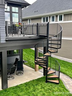 a house with a spiral staircase leading up to the second story