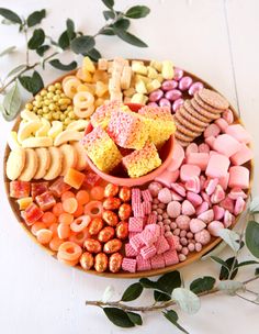 a platter filled with lots of different types of snacks and treats on top of each other