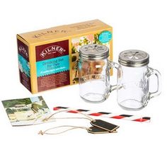 two mason jars are sitting next to each other with tags on them and a pair of scissors in front of the jar