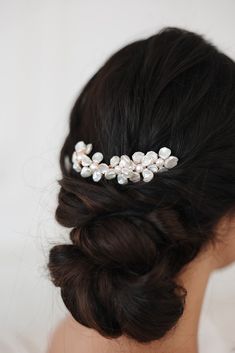 a woman wearing a hair comb with pearls on it