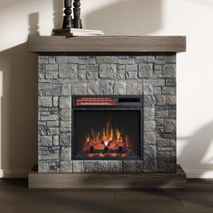 a stone fireplace with an electric fire in it