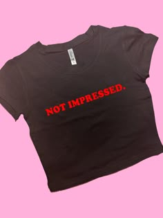 Not Impressed SNUG FIT Crop Top | Graphic Top | Gift For Her | Y2K Baby Tee | Y2K crop top | Gift for friend | Funny Slogan Comfy Top to Lounge in! Actual item may be lighter/darker than pictured. M A T E R I A L S - SNUG FIT - 100% RING SPUN COTTON - Shoulder Taping S I Z I N G - Size chart is available on our listing photos. S H I P P I N G  &  P R O D U C T I O N  T I M E - Production Time is 5 Business Days. (May be delayed during the Holiday Season) - Shipping Time is 2-6 Business Days. (Ma Fitted Black Crop Top With Logo Print, Black Logo Print Crop Top For Streetwear, Black Crop Top With Logo Print For Streetwear, Black Logo Print Crop Top T-shirt, Black Cropped Top With Logo Print, Black Y2k Tops With Funny Text, Streetwear Crop Top With Logo Print, Streetwear Cropped Crop Top With Logo Print, Streetwear Logo Print Crop Top