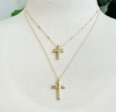 Get your bling on with our stylish Gold Cross Necklace! Choose between option one and two to rock this trendy accessory. A must-have addition to any outfit - dress it up or down for a versatile look. Perfect for all occasions! Gold Cross Pendant Jewelry For Party, Trendy Cross Necklace With Adjustable Chain, Trendy Gold Cross Jewelry, Party Cross-shaped Clavicle Chain Necklace, Trendy Adjustable Layered Necklace Gift, Party Clavicle Cross Necklace, Adjustable Cross-shaped Party Jewelry, Trendy Everyday Metal Layered Necklace, Trendy Everyday Layered Metal Necklace