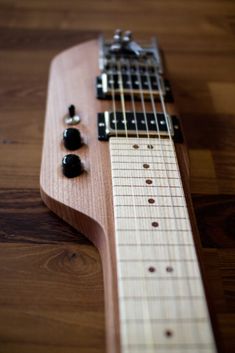 an electric guitar is laying on the floor with its strings still attached to it's neck