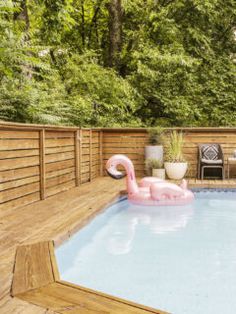 an inflatable pink flamingo floating on top of a pool